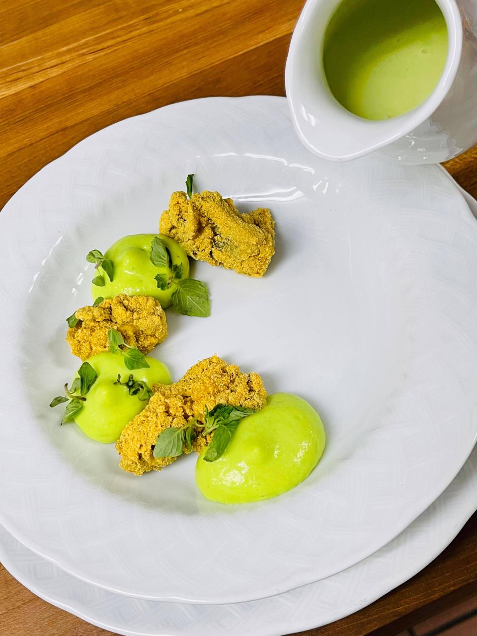 Herb-crusted medallions with green pea emulsion