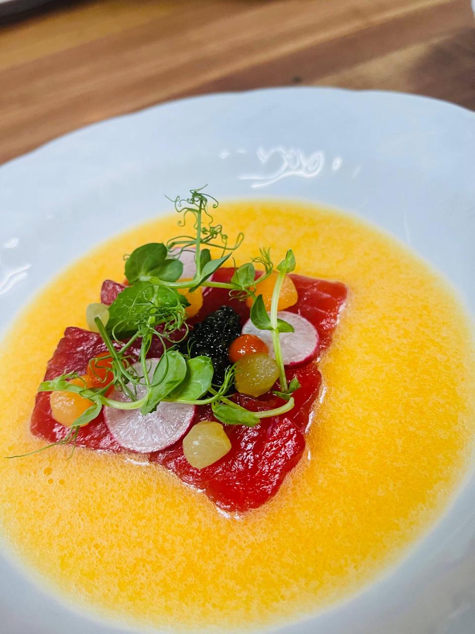 Cured tuna carpaccio with Sevruga caviar, radish, and citrus consommé