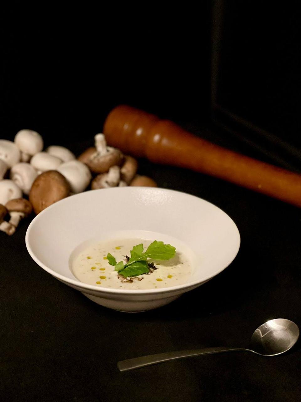 Creamy mushroom soup with micro-greens and white truffle oil