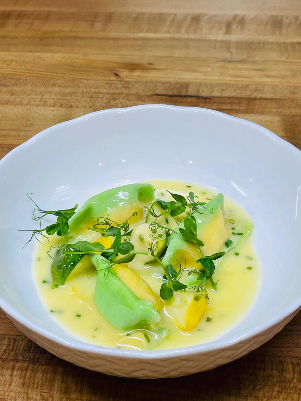 Handcrafted bicolored tortelloni pasta in saffron emulsion