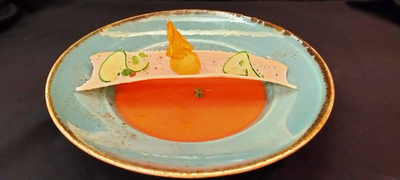 Chilled gazpacho soup with delicate cucumber tuile garnish